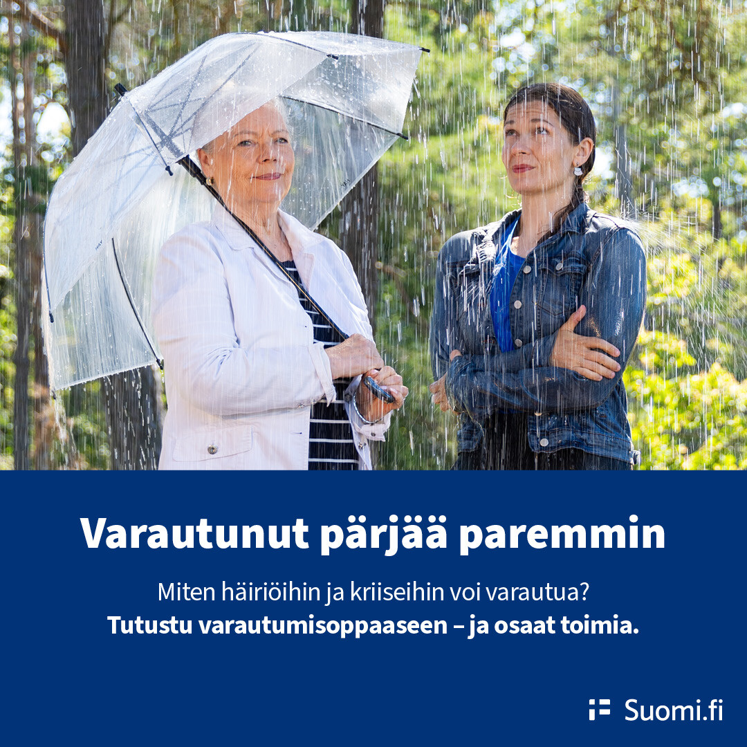 Puolikuvassa kaksi naista puistossa. Sataa vettä. Toisella on sateenvarjo, toinen värjöttelee surkeana ilman.